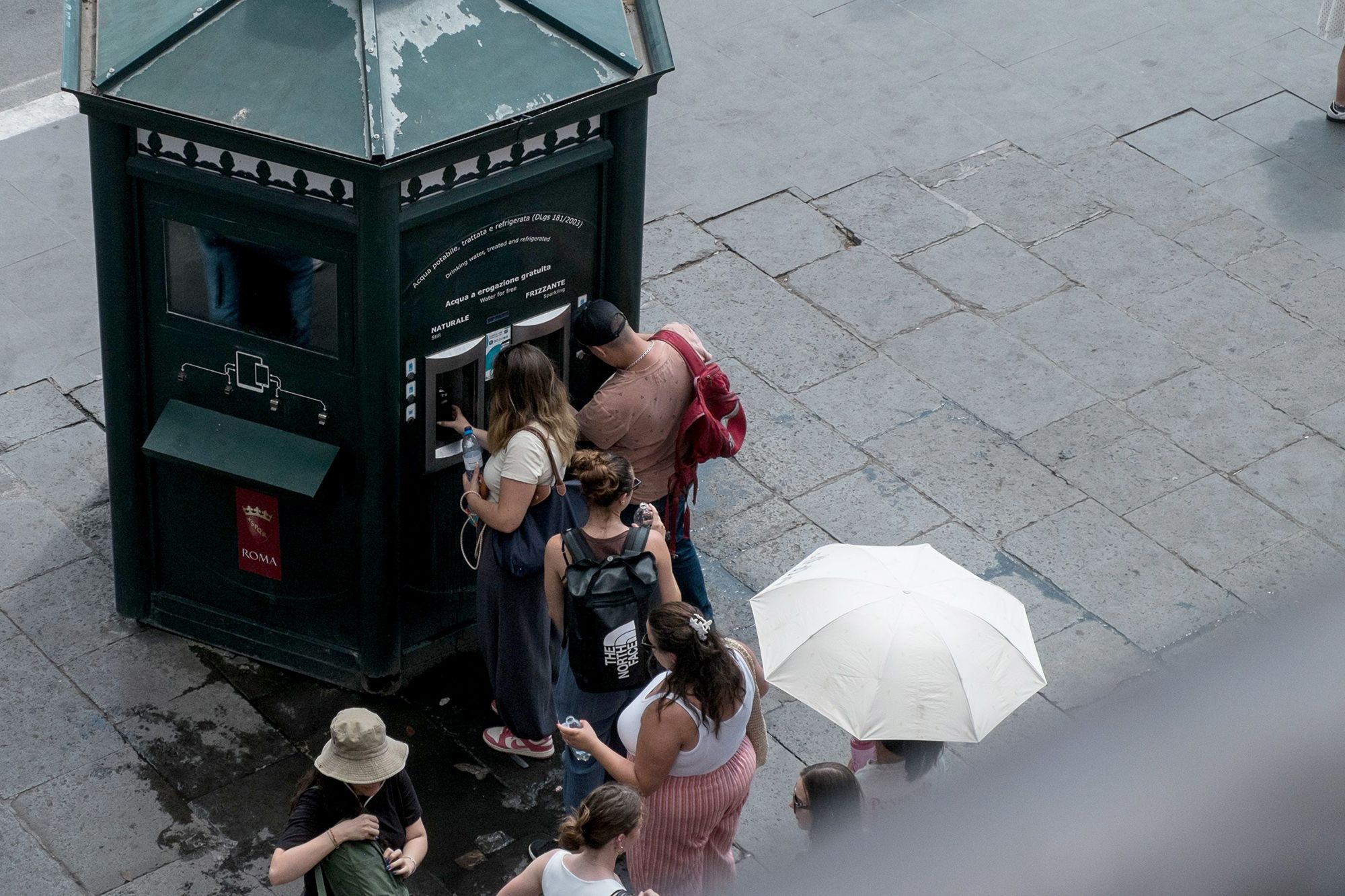 <i>Andrea Ronchini/NurPhoto/Shutterstock via CNN Newsource</i><br/>People line up to refill their water bottles at a public water dispenser near the Colosseum in Rome on July 4.