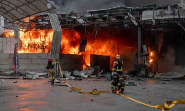Rescuers work at the site of a Russian drone strike at a gas station in Sumy