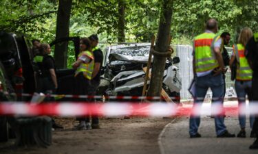 German police near the white vehicle involved in last night's attack against revelers of the Christopher Street Day Berlin pride parade on Sunday.