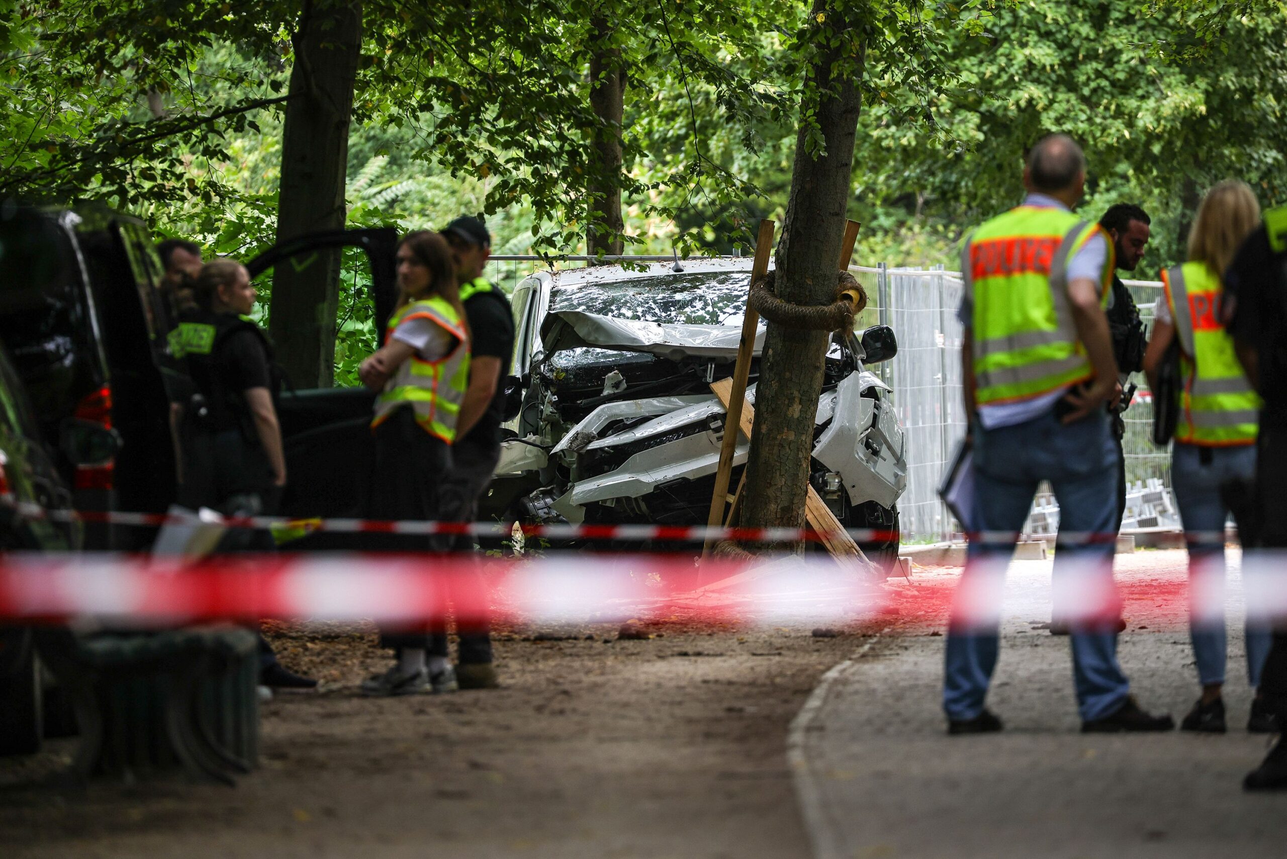<i>Omer Messinger/Getty Images via CNN Newsource</i><br/>German police near the white vehicle involved in last night's attack against revelers of the Christopher Street Day Berlin pride parade on Sunday.