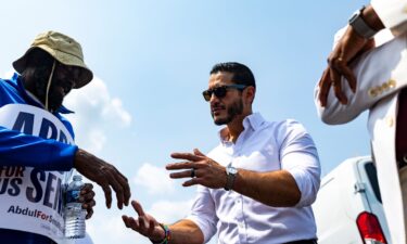 El-Sayed holds hands with church-goers during a closing prayer at New Bethel Missionary Baptist Church.