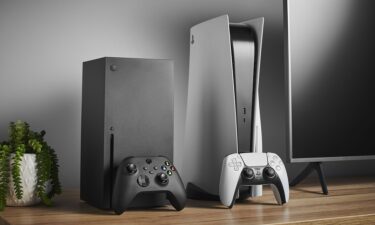 The Microsoft Xbox Series X (L) and Sony PlayStation 5 home video game consoles are shown alongside a television and soundbar on November 3
