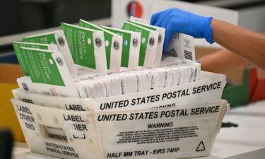 An election worker processes mail-in ballots at the Los Angeles County Ballot Processing Center during California's state primary election in the City of Industry