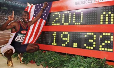 Michael Johnson celebrates by the timing board after setting the world record in the men's 200m at the 1996 Atlanta Summer Olympics.