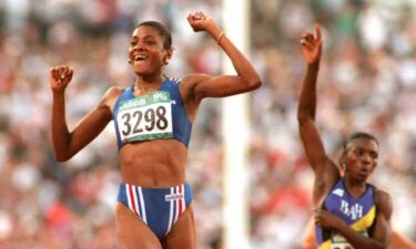 Marie-Jose Perec celebrates on the track after crossing the line during the 1996 Atlanta Summer Olympics.