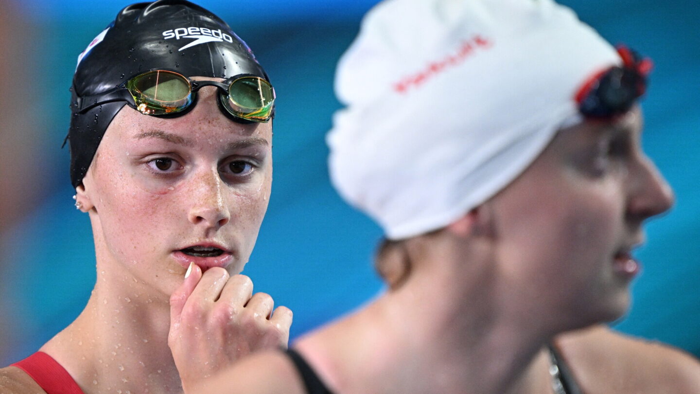 Canada's Summer McIntosh (L) and USA's Katie Ledecky react after a heat for the women's 400m freestyle event during the Budapest 2022 World Aquatics Championships at Duna Arena in Budapest on June 18