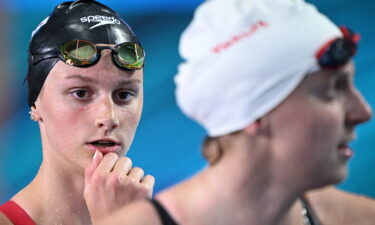 Canada's Summer McIntosh (L) and USA's Katie Ledecky react after a heat for the women's 400m freestyle event during the Budapest 2022 World Aquatics Championships at Duna Arena in Budapest on June 18