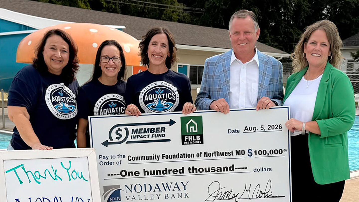 Andrew County Aquatics Initiative committee members Jamie Baker, Christie Lightle and Diane Gould, president, accept a $100,000 contribution from Nodaway Valley Bank, represented by CEO James G. Robinson and local branch manager, Chanda Proffit, and the Federal Home Loan Bank of Des Moines toward renovation of Savannah’s municipal swimming pool complex.    