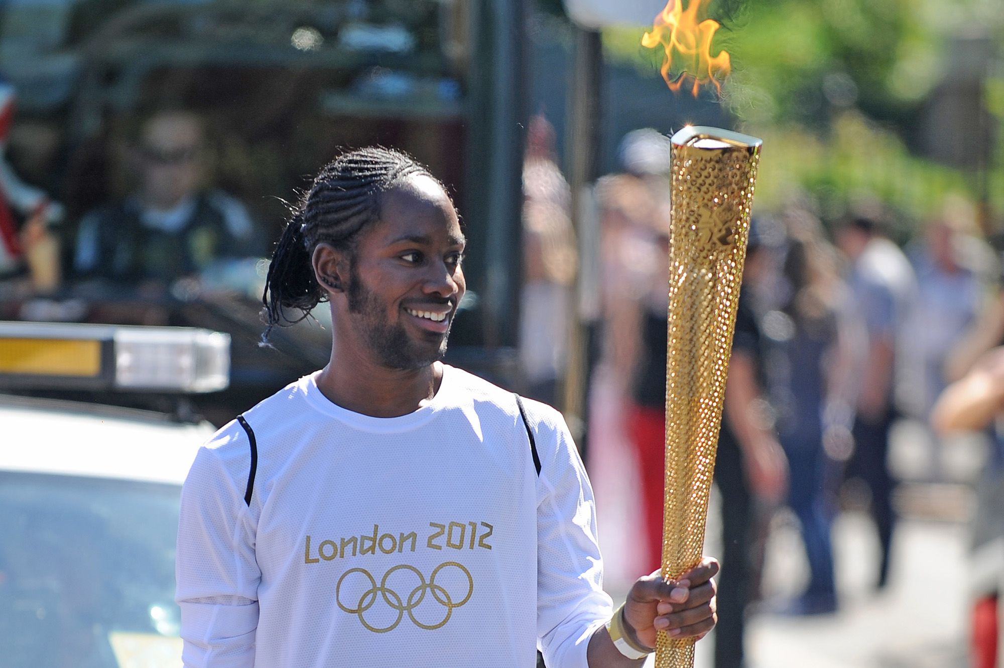 <i>Joe Giddens/LOCOG/PA/AP via CNN Newsource</i><br/>Torchbearer Jason Arday carries the Olympic Flame on the Torch Relay leg between Sutton and Merton