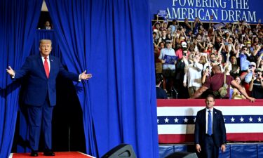 President Donald Trump greets the audience before speaking at General Motors’ Milford Proving Grounds on July 27