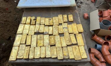 Gold bars line the table after they are discovered by construction workers in Belgium.