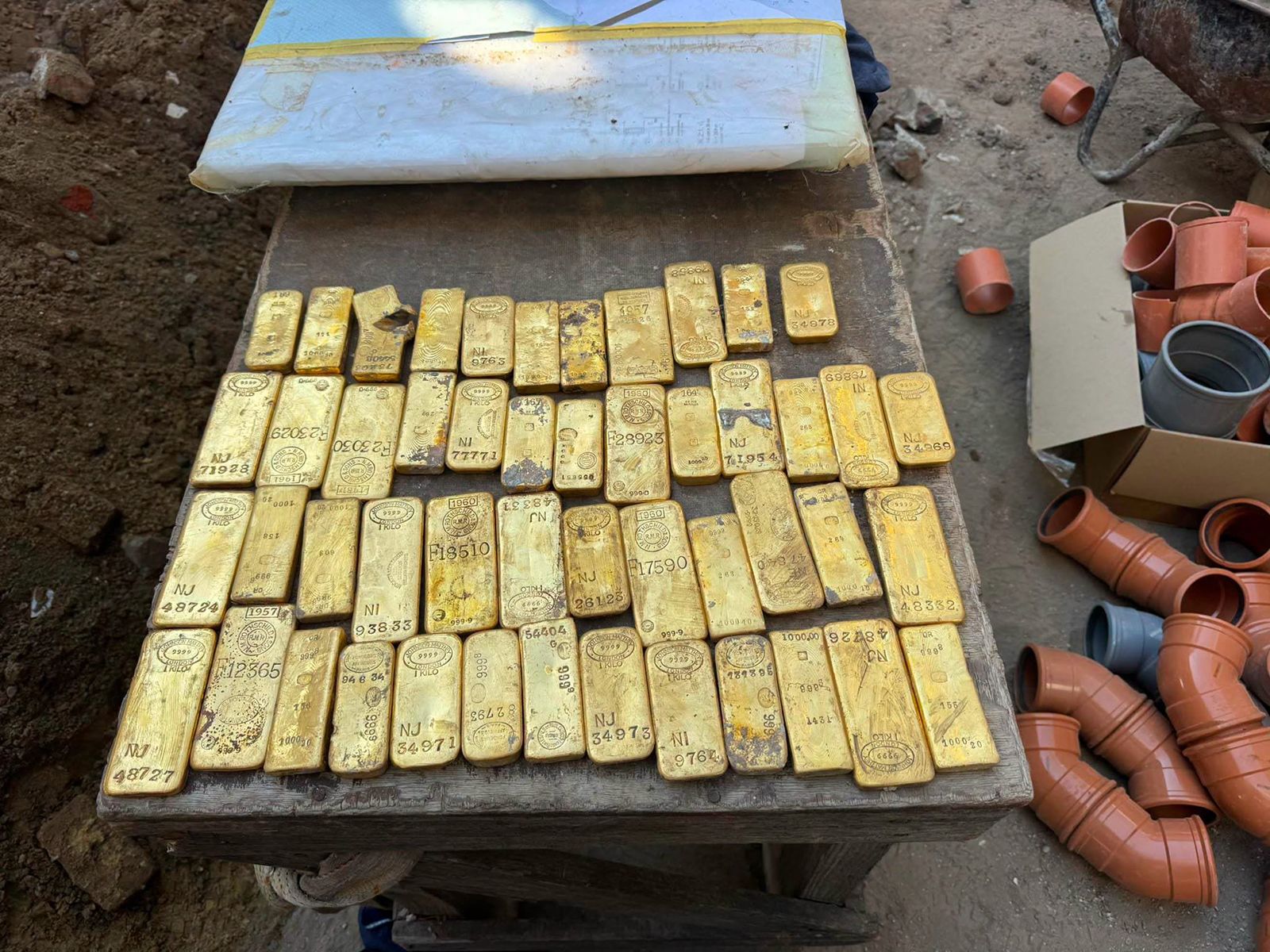 <i>Police department Dendermonde/Facebook via CNN Newsource</i><br/>Gold bars line the table after they are discovered by construction workers in Belgium.