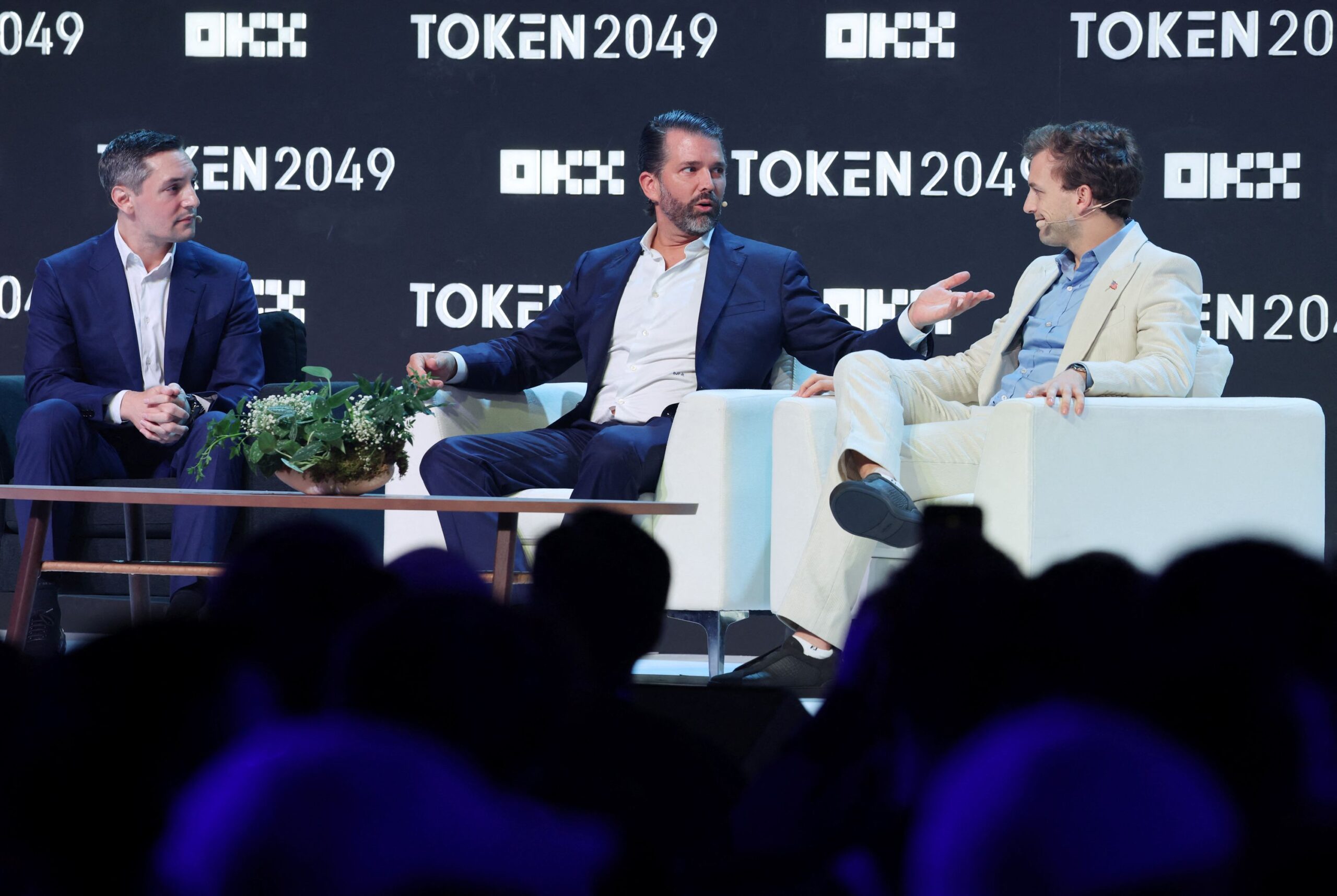 <i>Edgar Su/Reuters via CNN Newsource</i><br/>World Liberty co-founder Donald Trump Jr. speaks with CEO Zach Witkoff and Founder and Chief Executive of Wachsman