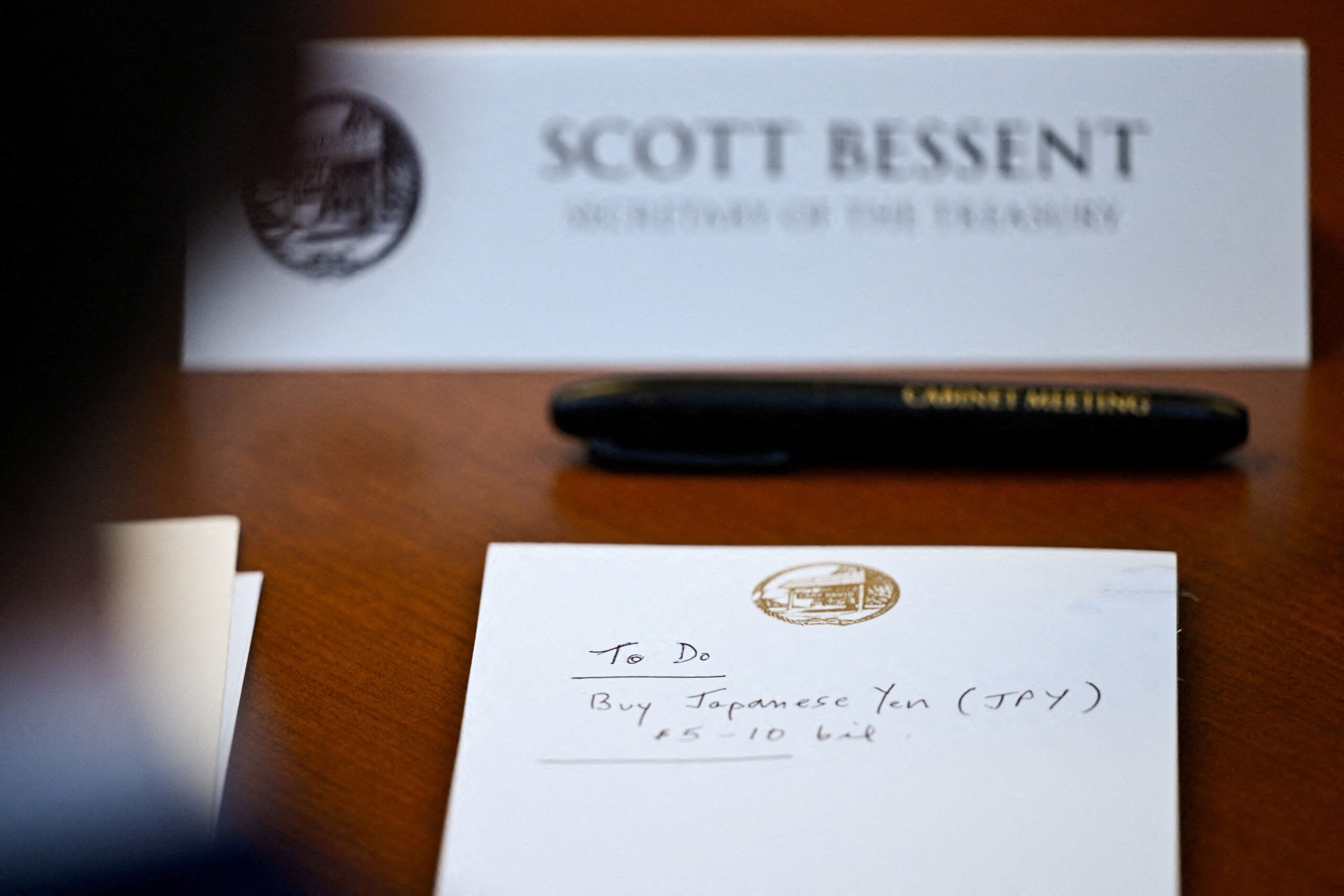 <i>Daniel Heuer/Reuters via CNN Newsource</i><br/>A notepad in front of US Secretary of the Treasury Scott Bessent reads 
