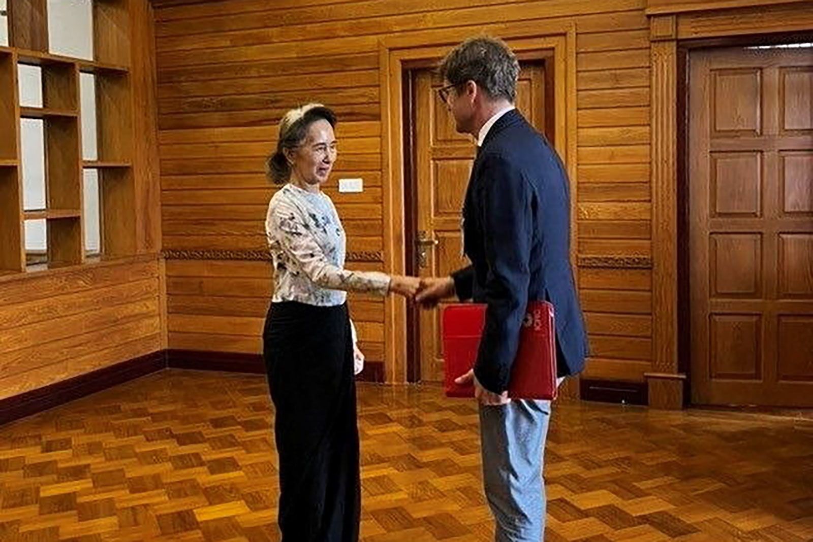 <i>Khine Khine Soe/Myanmar Government/Reuters via CNN Newsource</i><br/>Myanmar's detained former leader Aung San Suu Kyi shakes hands with Myanmar's Resident Representative and Head of Delegation for the International Committee of the Red Cross (ICRC) Arnaude de Baecque