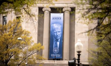 An image of President Donald Trump hangs from the Justice Department in Washington