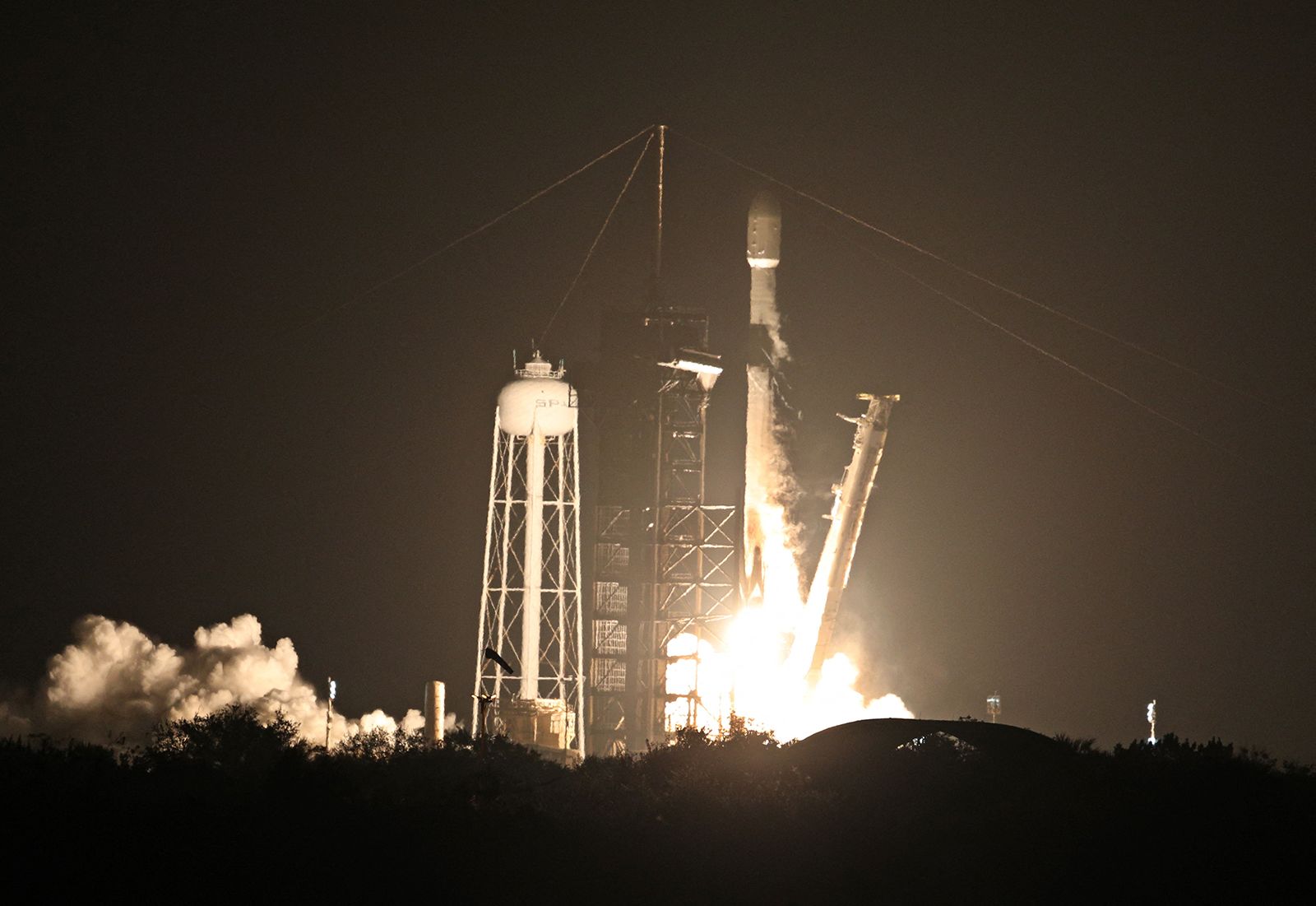 <i>Gregg Newton/AFP/Getty Image via CNN Newsource</i><br/>The SpaceX Falcon 9 rocket is seen arcing over the sky after liftoff in 2025.