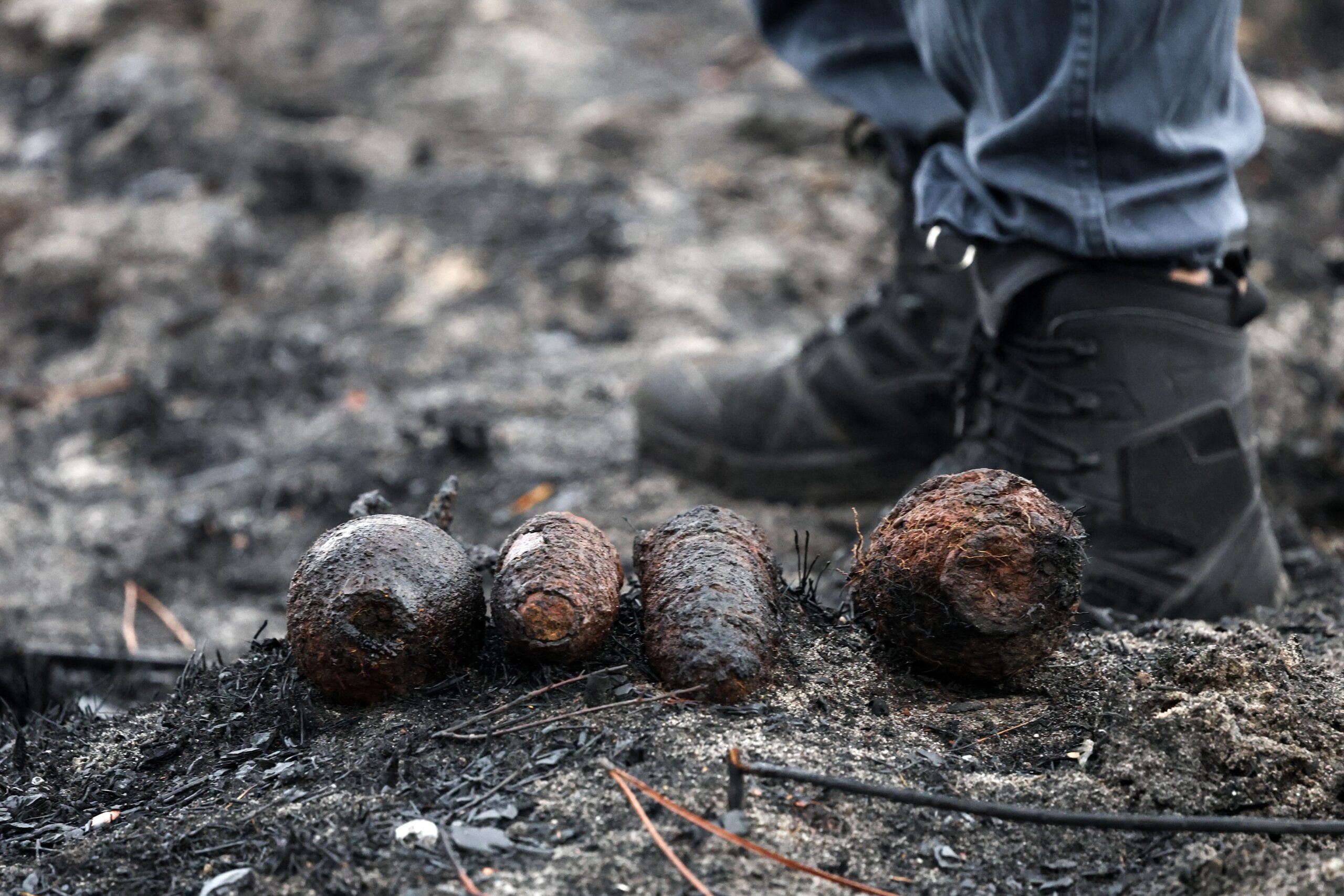 <i>Romain Perrocheau/AFP/Getty Images via CNN Newsource</i><br/>Bomb disposal experts work on a site after the discovery of shells from World War II in a neighborhood of Le Porge on Monday.