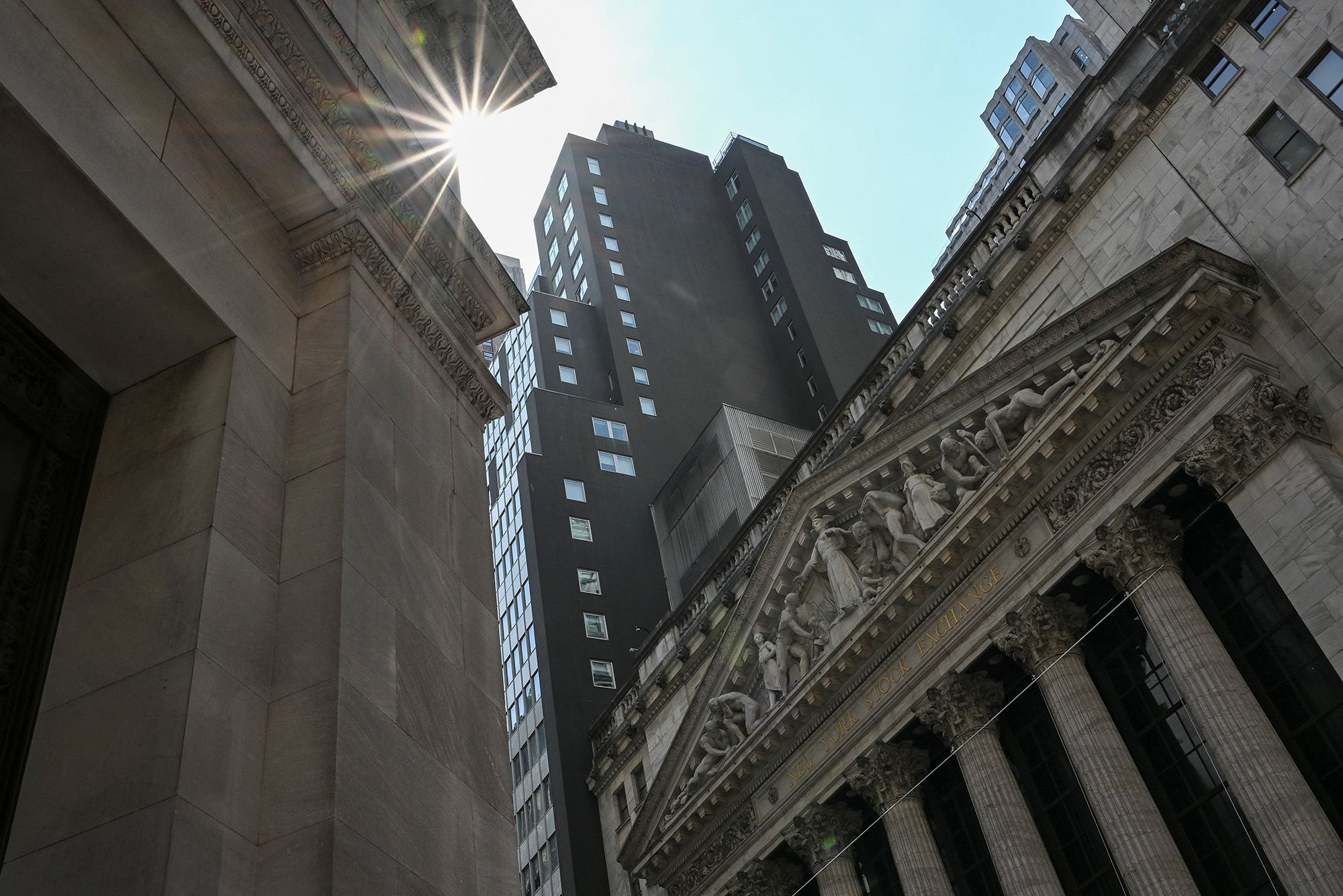 <i>Angela Weiss/AFP/Getty Images via CNN Newsource</i><br/>An exterior view shows the New York Stock Exchange (NYSE) on July 24. The Dow on Monday closed above 53