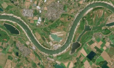 A cargo ship passes a huge exposed sandbar on the Rhine River during an ongoing drought and heat wave on July 30