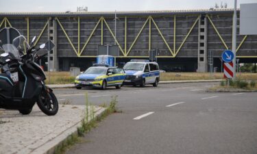 Two police vehicles parked at Leipzig/Halle Airport Wednesday after the airport suspended flight operations overnight.