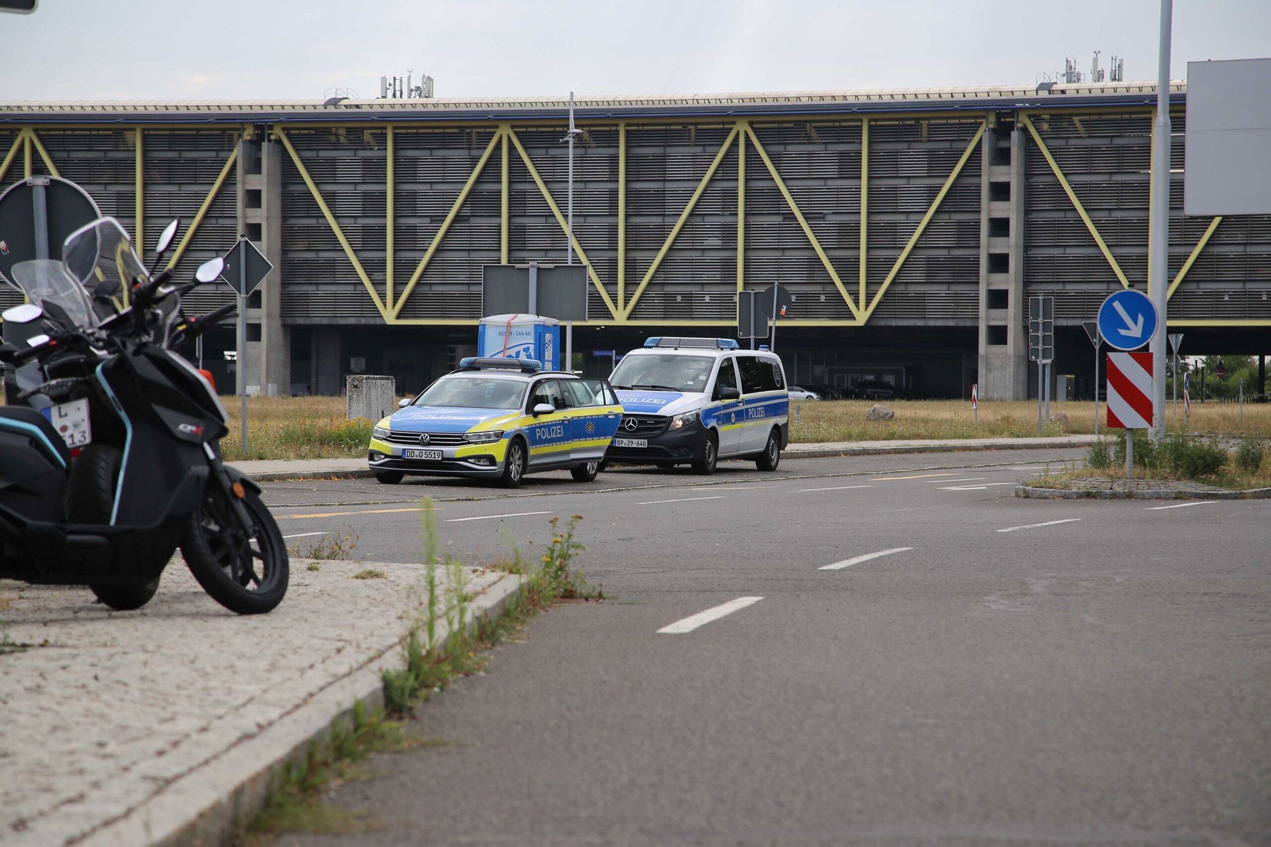 <i>Tobias Junghanns/picture-alliance/dpa/AP via CNN Newsource</i><br/>Two police vehicles parked at Leipzig/Halle Airport Wednesday after the airport suspended flight operations overnight.