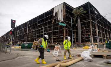A person wears a face mask as a massive warehouse fire at a cold storage facility continues to burn and spread smoke around the city on June 20 in Los Angeles