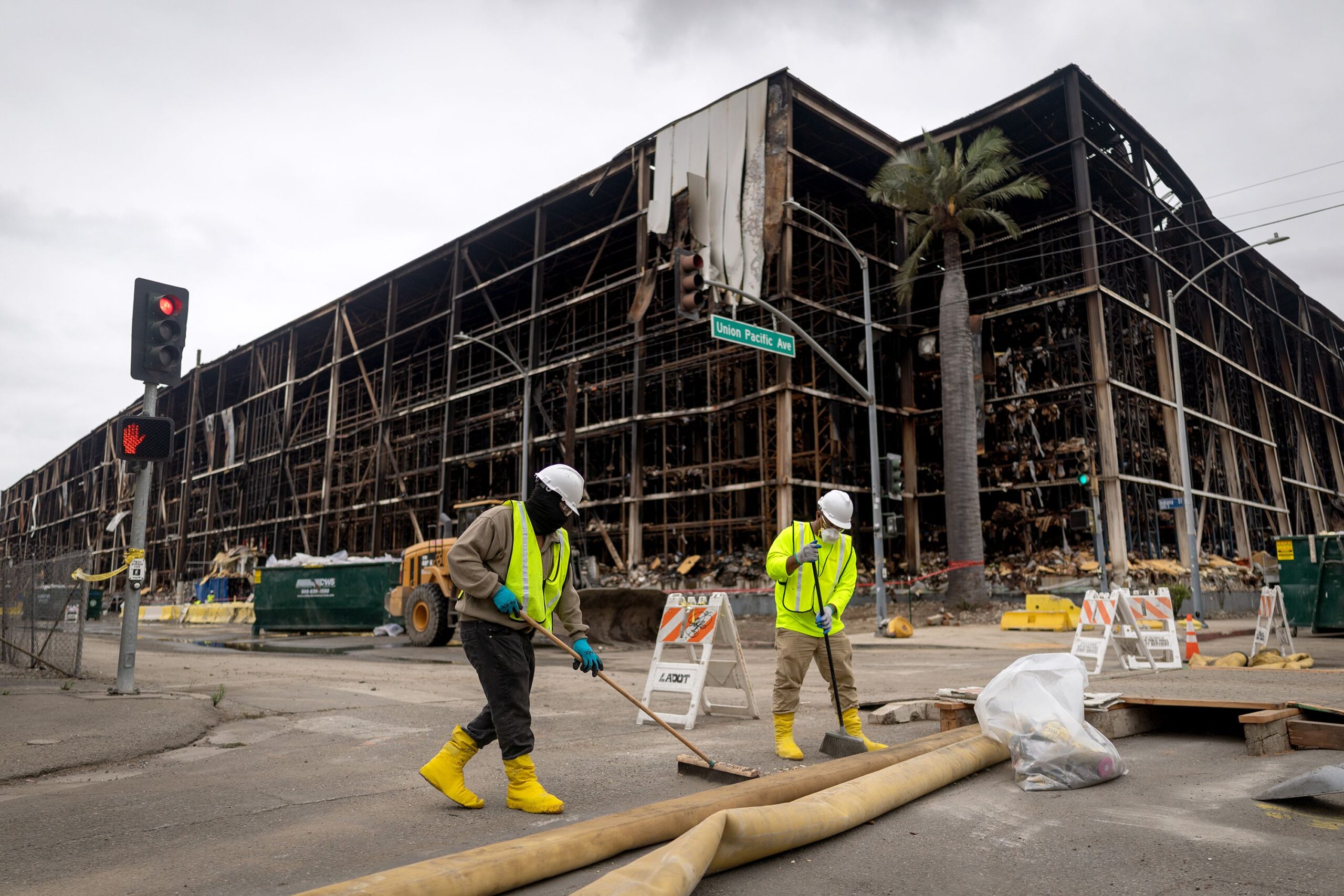<i>Mario Tama/Getty Images via CNN Newsource</i><br/>A person wears a face mask as a massive warehouse fire at a cold storage facility continues to burn and spread smoke around the city on June 20 in Los Angeles