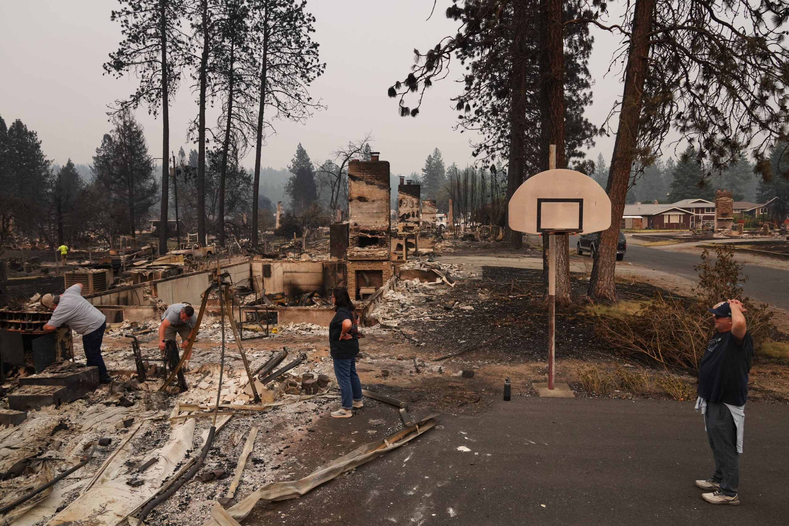 <i>Lindsey Wasson/AP via CNN Newsource</i><br/>Mike Wirth holds family photos retrieved from his father-in-law's home after a wildfire hit the northwest part of Spokane