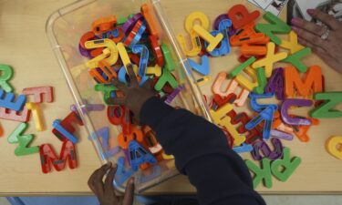 A student looks for a certain letter during a reading and writing lesson at a Head Start program run by Easterseals