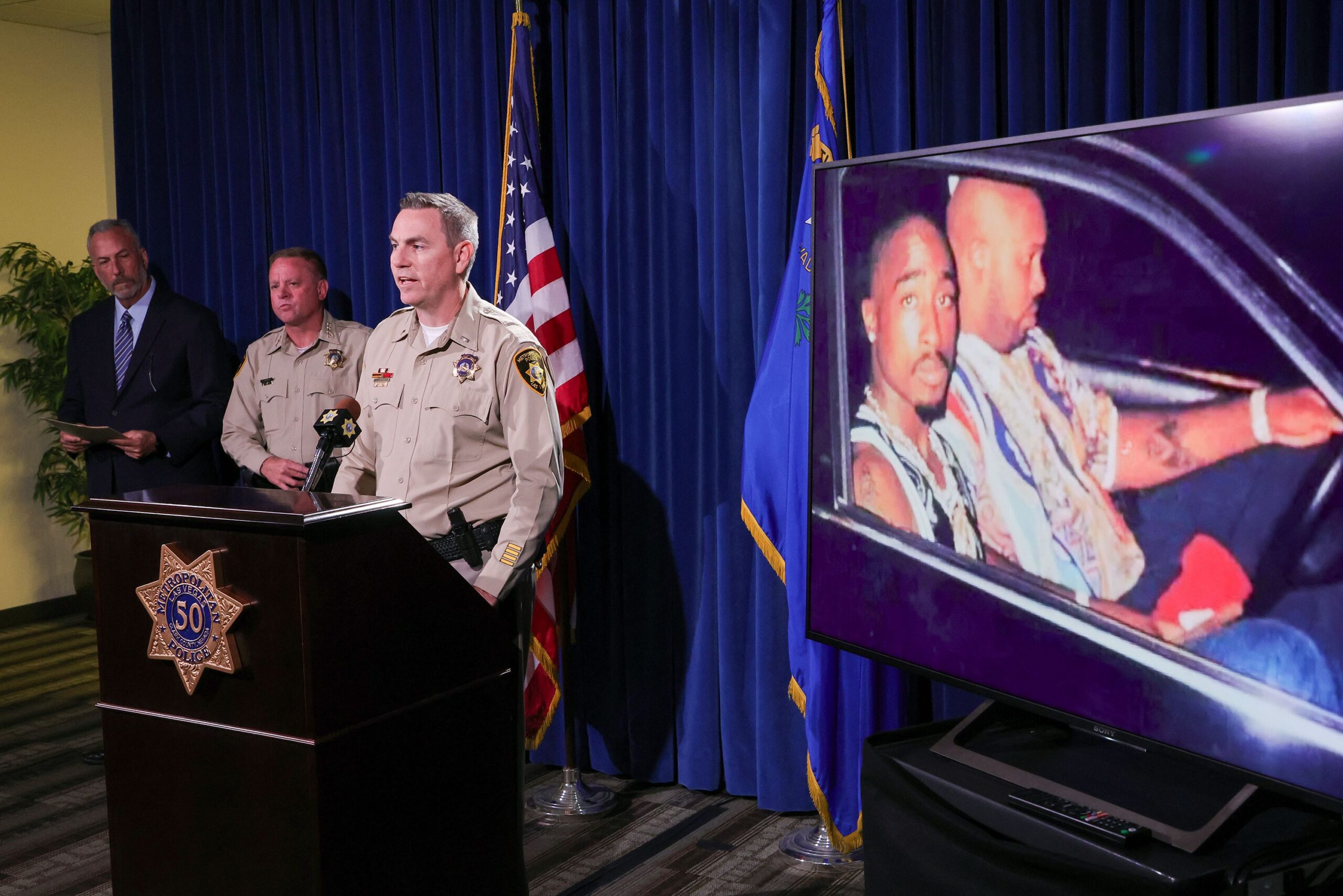 <i>Ethan Miller/Getty Images via CNN Newsource</i><br/>Prosecutors announced charges against Duane Davis in September 2023 next to an image of Tupac Shakur (left) and Marion 