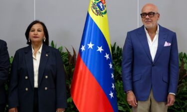 Venezuela's National Assembly President Jorge Rodriguez and former opposition lawmaker Dinorah Figuera attend the opening session of the national dialogue in Caracas