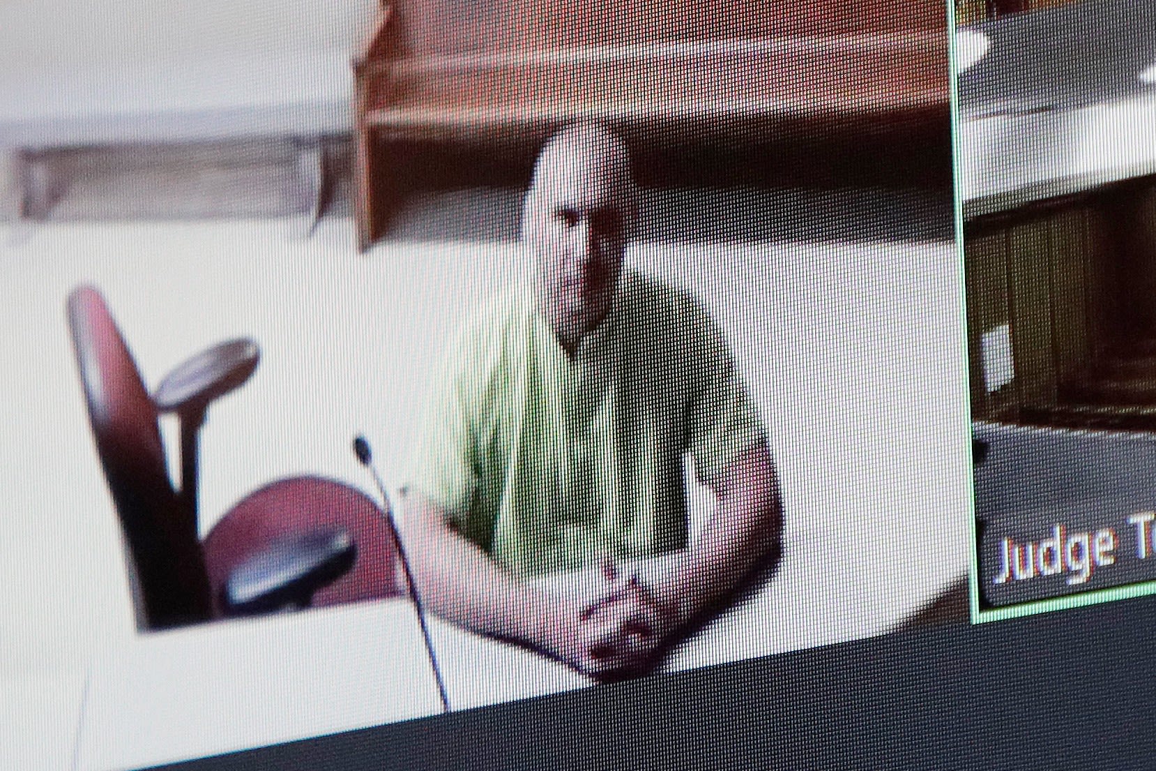 <i>Young Kwak/AP via CNN Newsource</i><br/>Arson suspect Aaron Farinacci waits for his initial court appearance by video at the county courthouse in Spokane