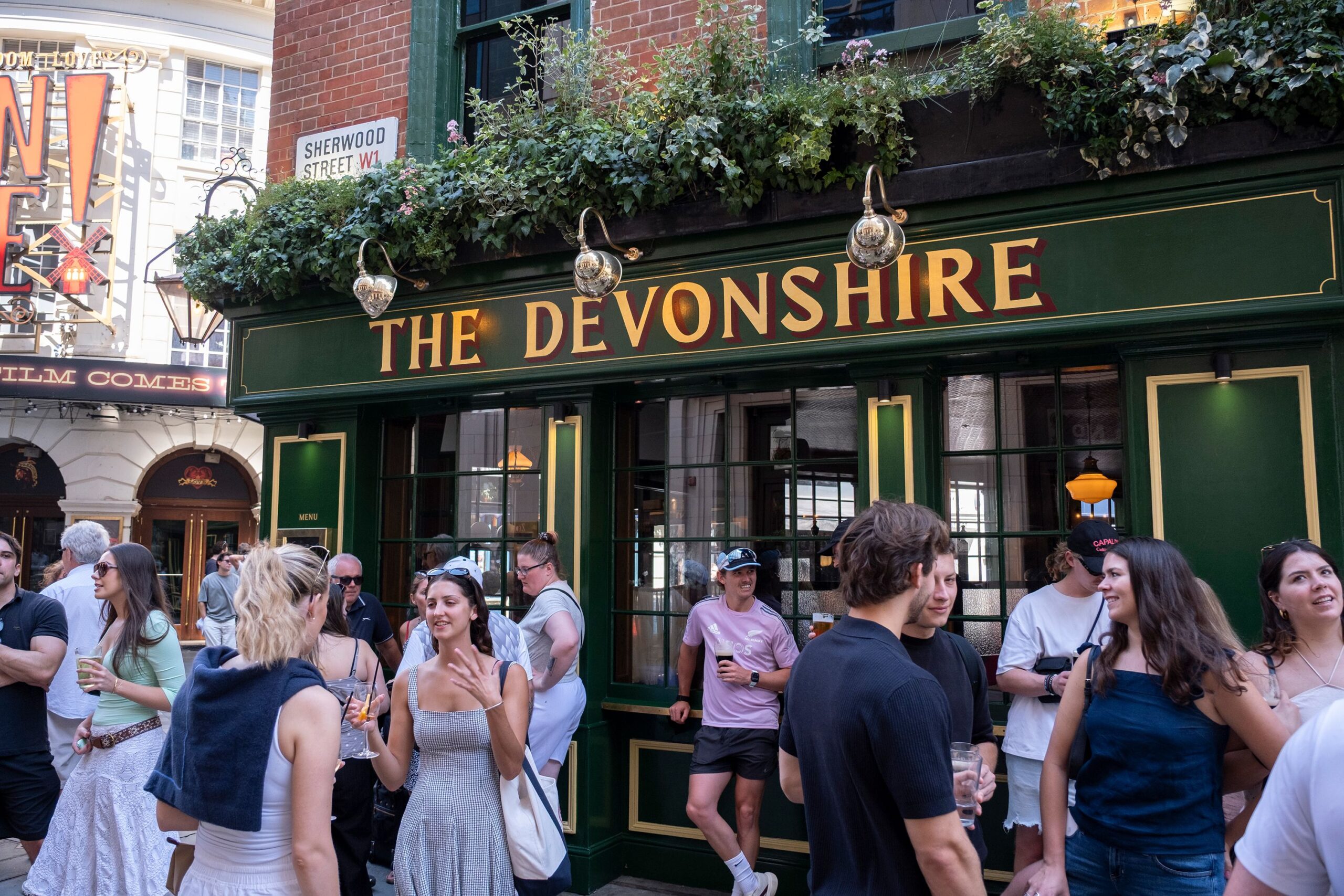 <i>Mike Kemp/In Pictures/Getty Images via CNN Newsource</i><br/>People standing around outside pubs with drinks is a familiar feature of the British summer.