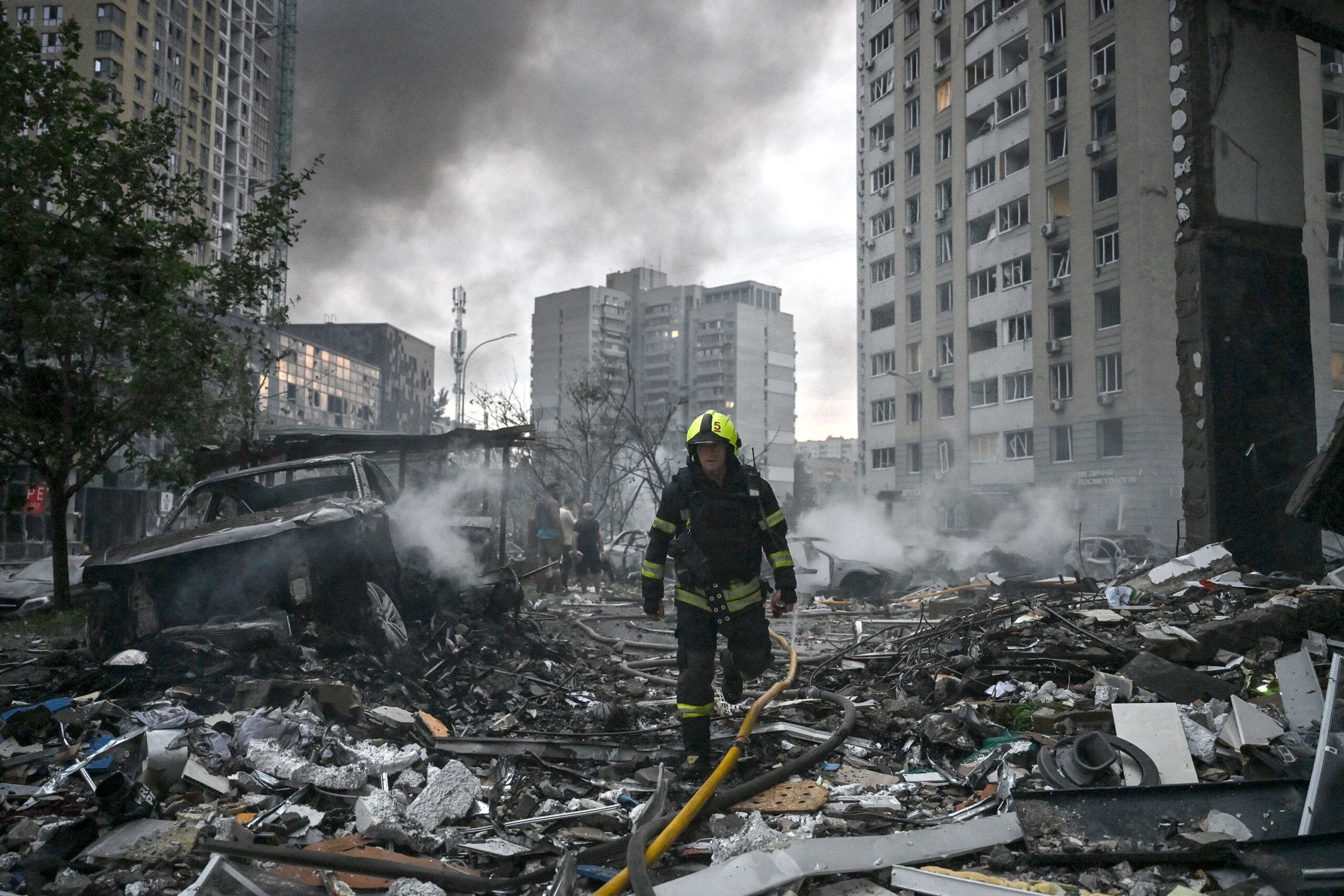 <i>Genya Savilov/AFP/Getty Images via CNN Newsource</i><br/>A rescuer worker walks through the rubble of a multi-story residential building damaged in a Russian ballistic missile strike in the Ukrainian capital of Kyiv on July 6.