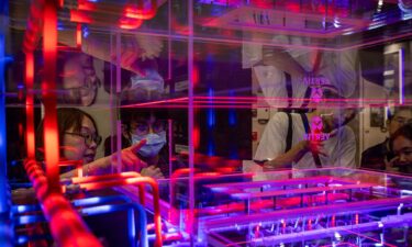 The reflection of attendees is seen on a glass window showcasing GIGABYTE server racks at a booth during COMPUTEX on June 02