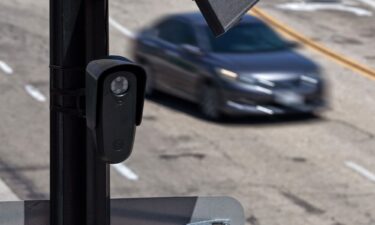 A Flock camera is mounted to a light pole on August 3