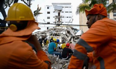 Mexican rescuers take part in the search for survivors amid the rubble of a collapsed building following an earthquake in Cali