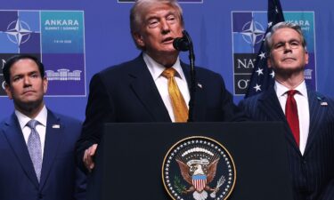 President Donald Trump speaks with the media aboard Air Force One