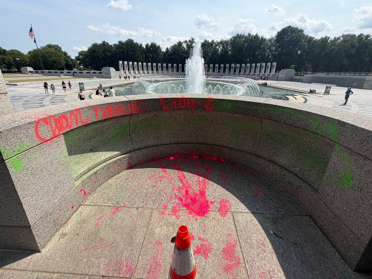 <i>Andrew Leyden via CNN Newsource</i><br/>Graffiti reading “Clean hands dirty $” is visible in the World War II Memorial in Washington