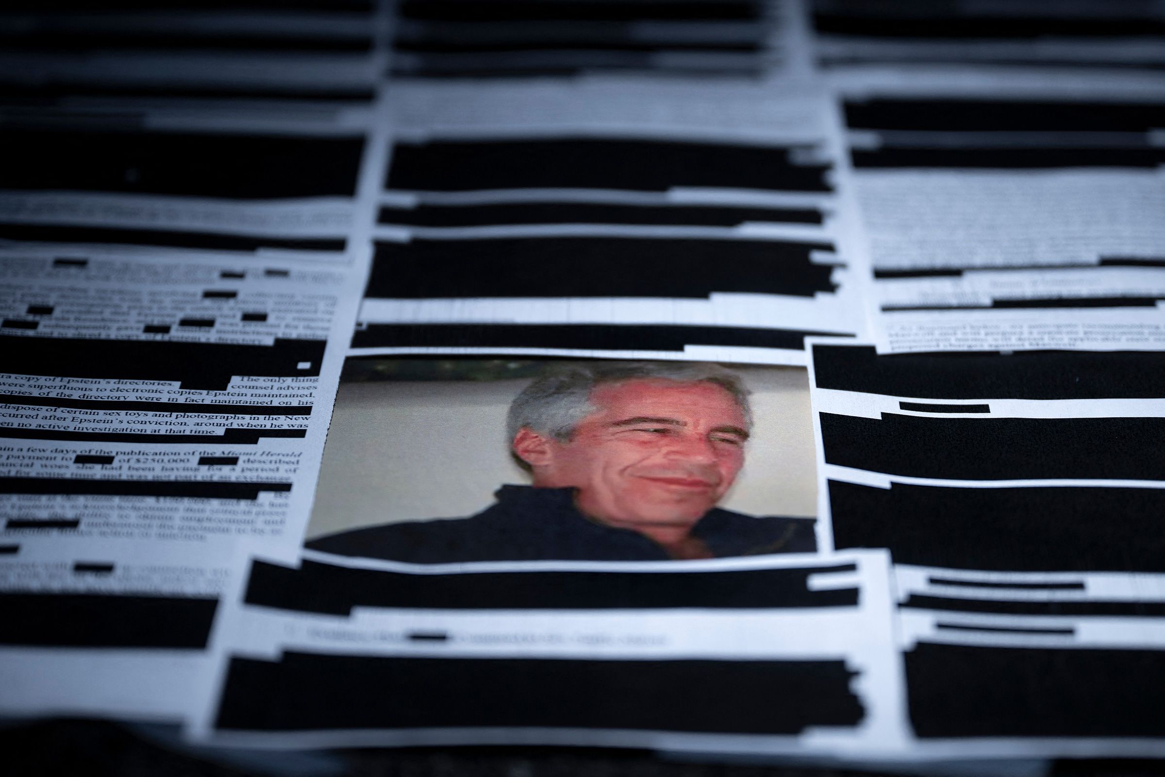 <i>Brendan Smialowski/AFP/Getty Images via CNN Newsource</i><br/>This photo illustration shows redacted documents from the Epstein Library files released by the US Department of Justice in Washington