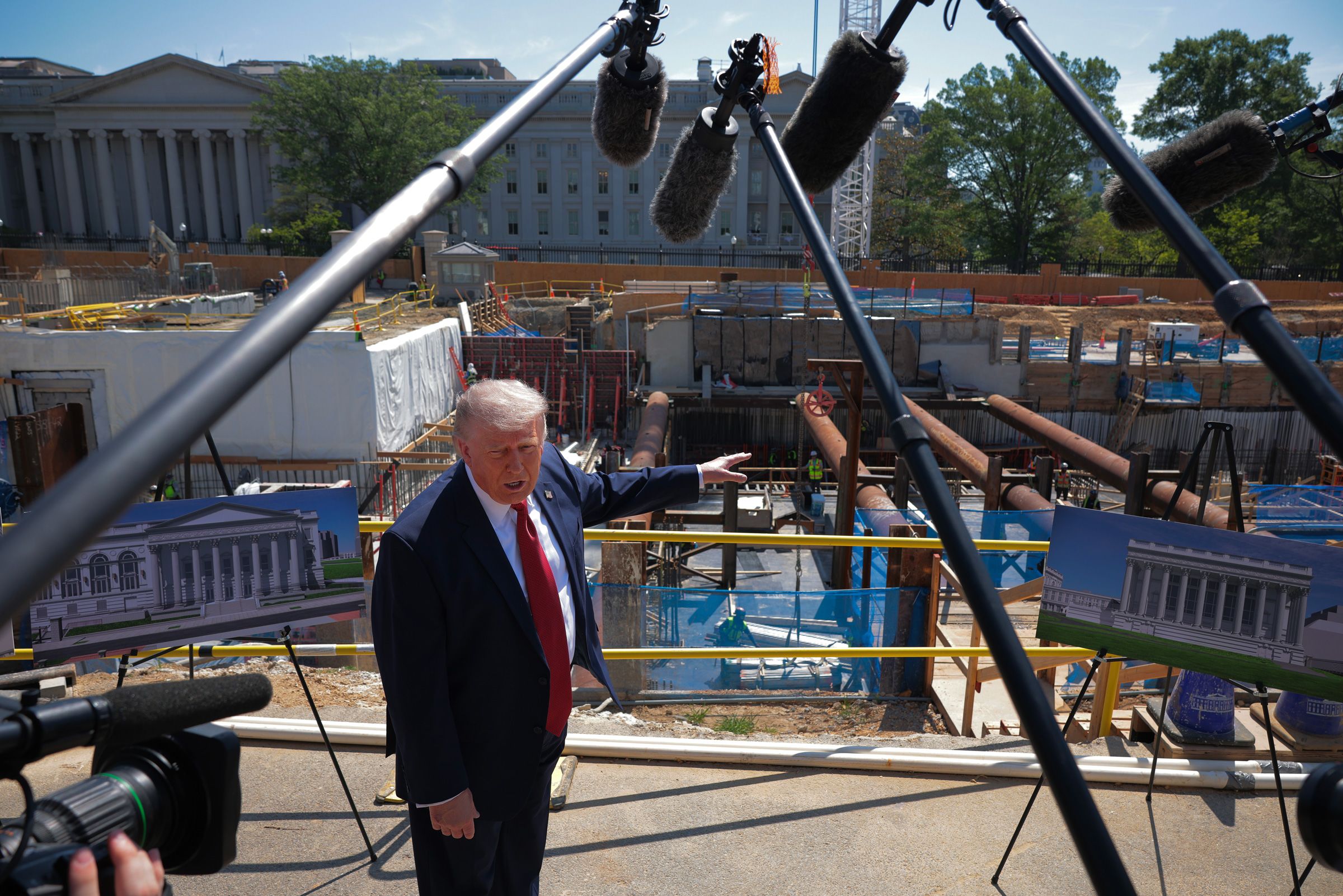 <i>Chip Somodevilla/Getty Images via CNN Newsource</i><br/>President Donald Trump talks to reporters about his proposed White House ballroom next to the worksite on May 19 in Washington