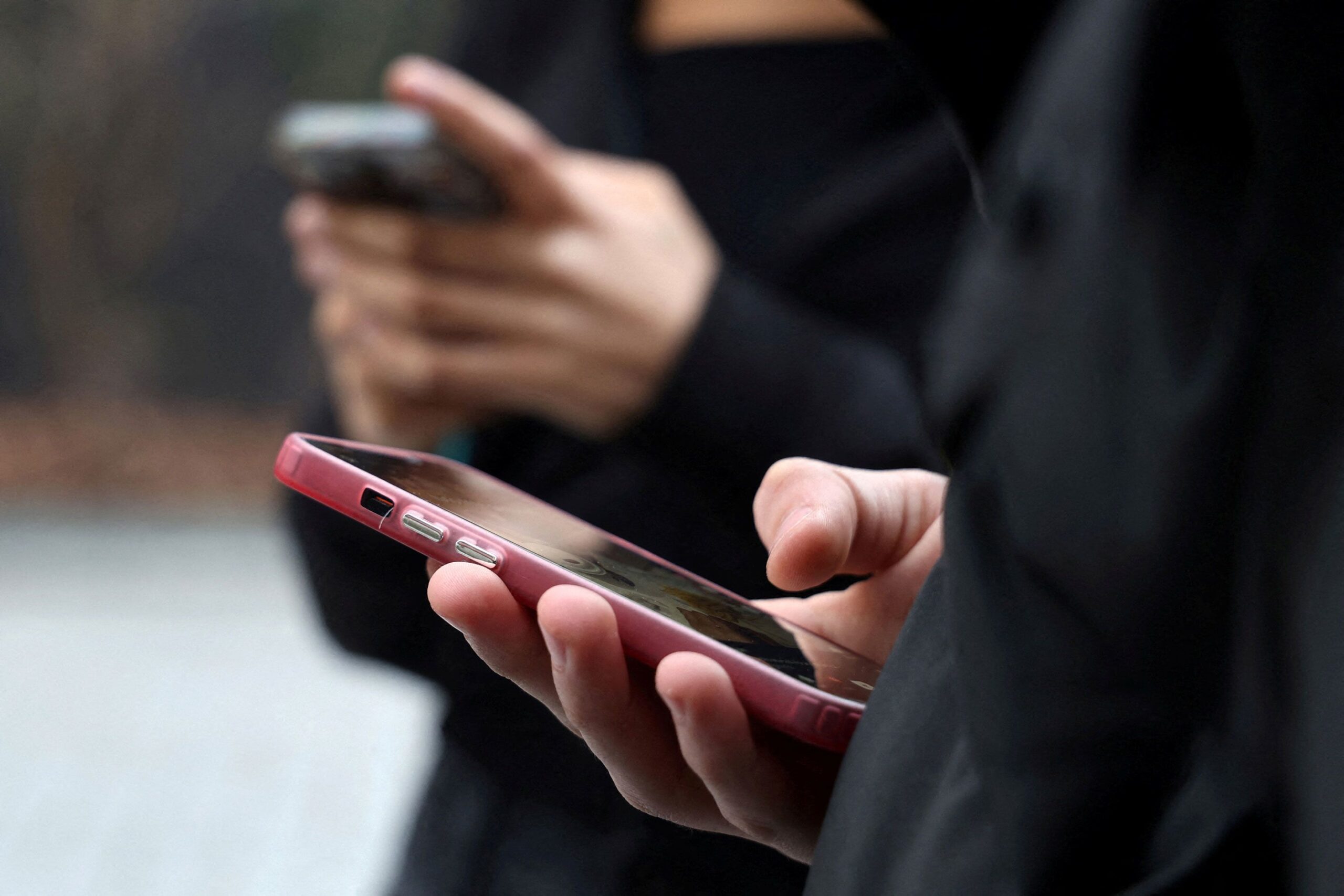 <i>Manuel Ausloos/Reuters via CNN Newsource</i><br/>Teenagers pictured looking at their mobile phone screens in Paris.