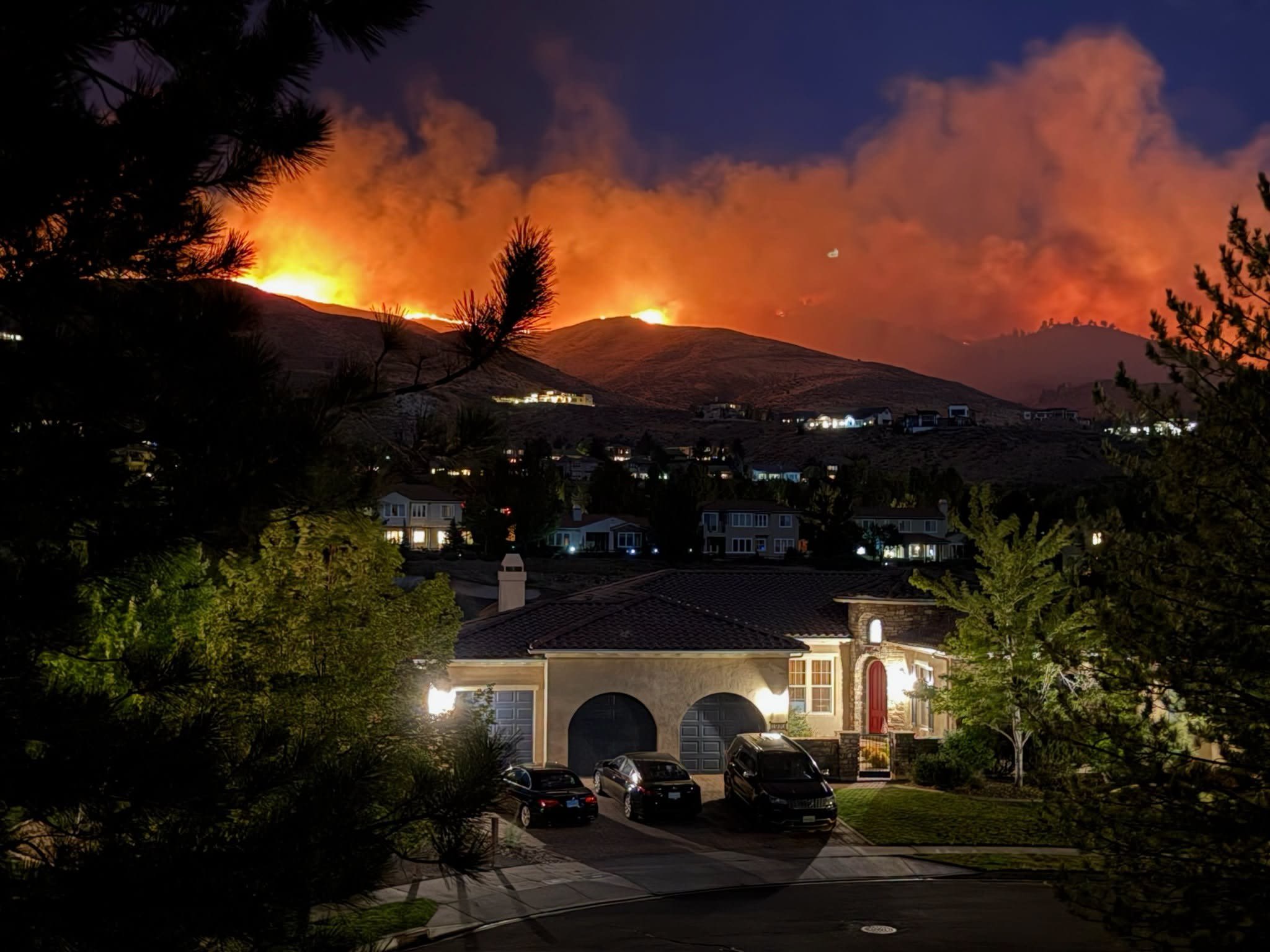 <i>Truckee Meadows Fire Protection via CNN Newsource</i><br/>Photos from the Truckee Meadows Fire Protection District shows flames in the distance progressing towards residential areas in Reno
