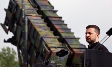 Volodymyr Zelensky stands in front of a Patriot anti-aircraft missile system during a visit to a military training area in Germany in 2024.