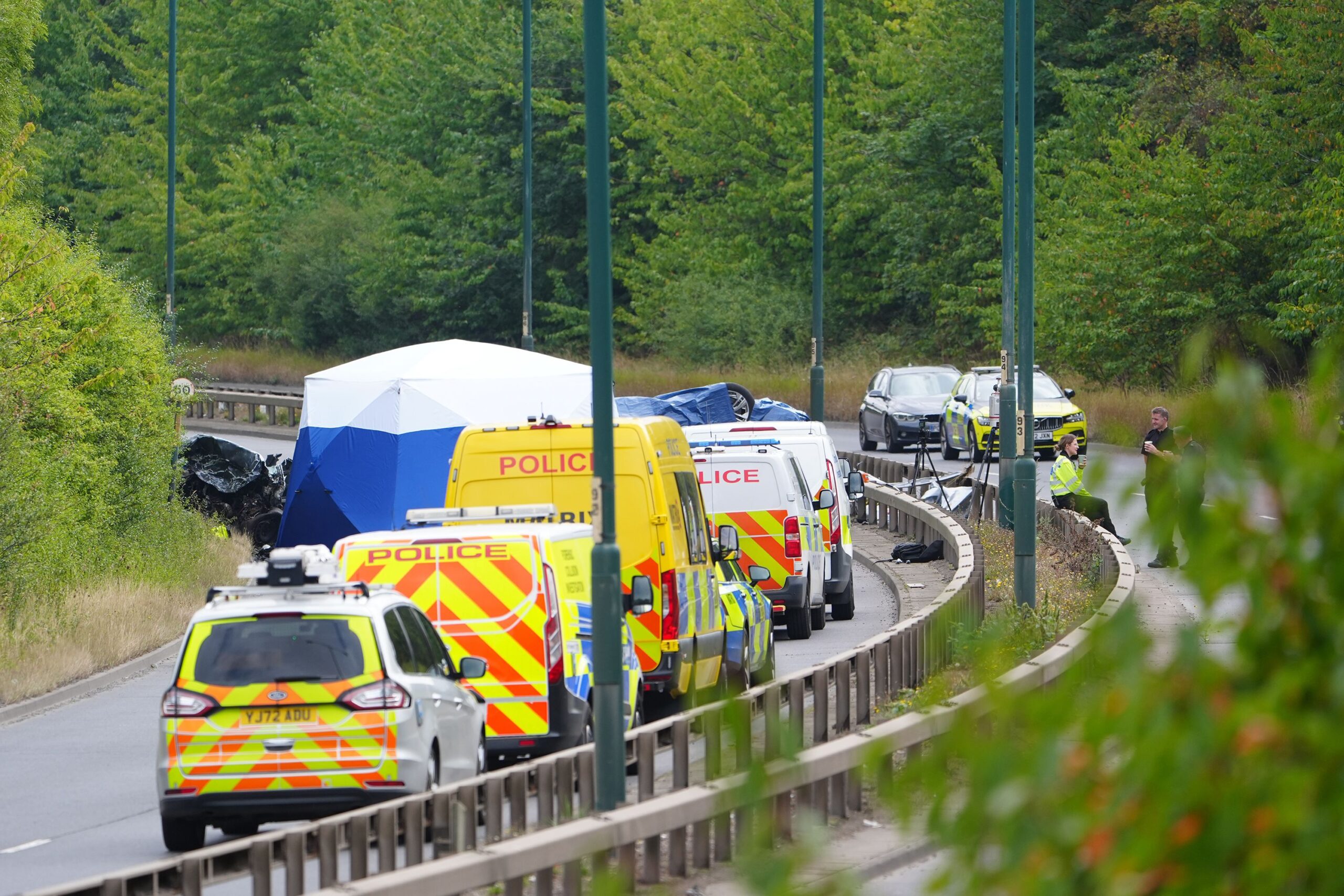 <i>Owen Humphreys/PA/AP via CNN Newsource</i><br/>Police officers at the scene of a fatal crash involving a police car and a Volkswagen Passat on the A66 in South Bank