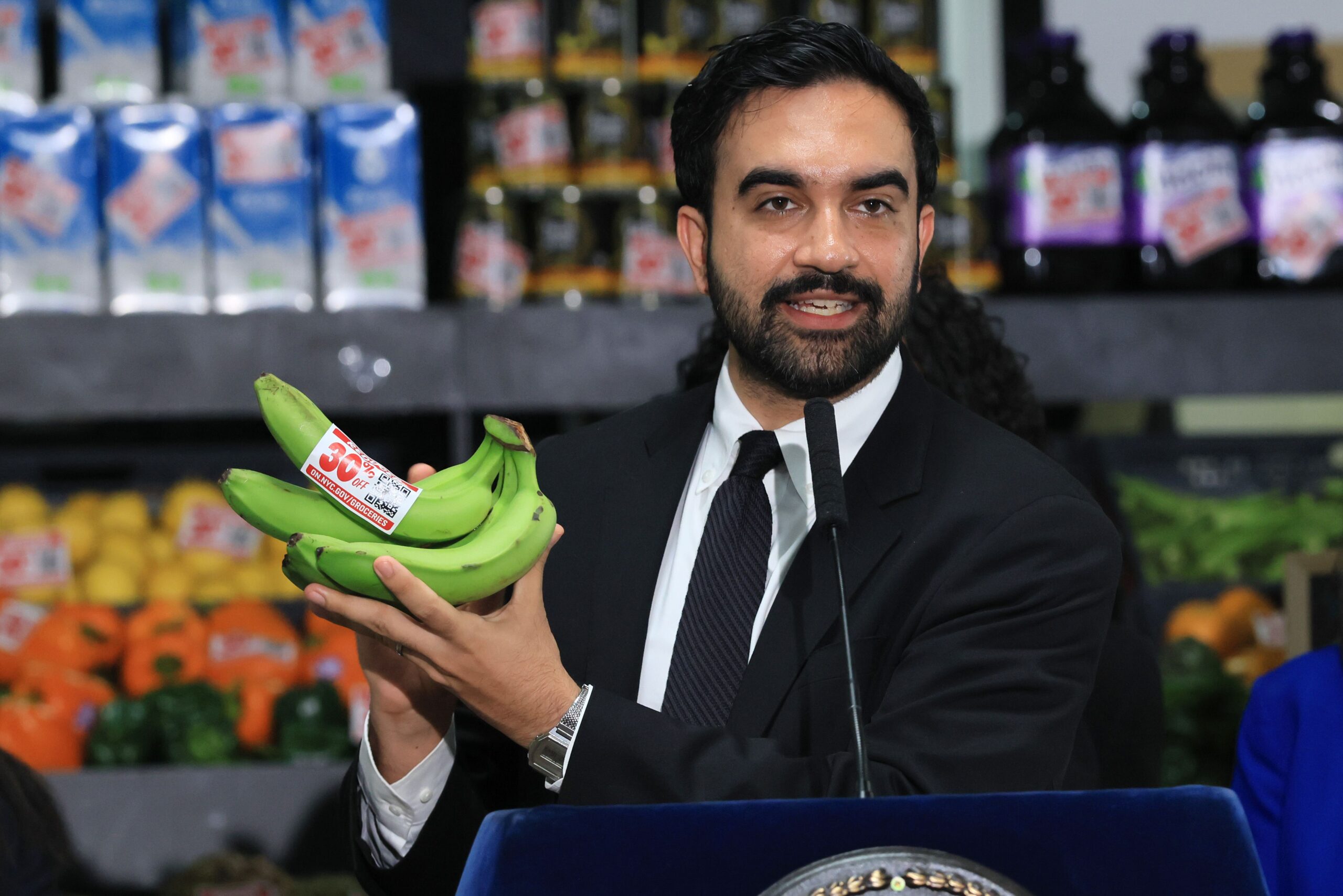 <i>Spencer Platt/Getty Images/File via CNN Newsource</i><br/>New York City Mayor Zohran Mamdani holds up bananas as he announced details of his plan to open five city-owned grocery stores on July 27 in the Brooklyn borough of New York City.
