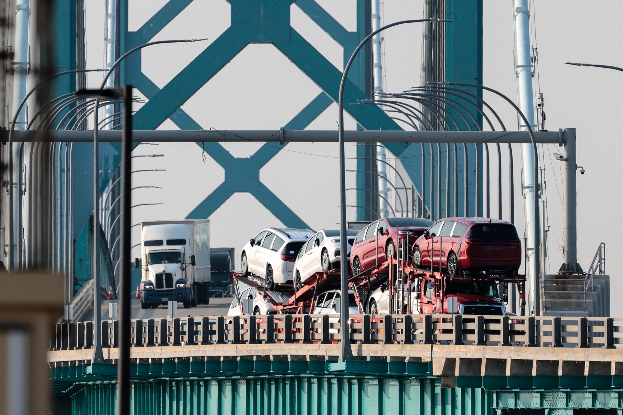 <i>Jeff Kowalsky/AFP/Getty Images via CNN Newsource</i><br/>Trucks cross the Ambassador Bridge connecting Windsor