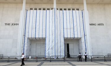 Security keeps watch at the main entrance to the John F. Kennedy Center for the Performing Arts on a day when the center's board voted to inscribe onto the building “Restored and Renovated by President Donald J. Trump”