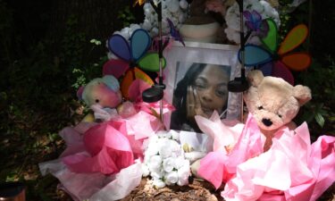 A makeshift memorial honoring Tasia Fortune stands in the backyard of the property where her body was found